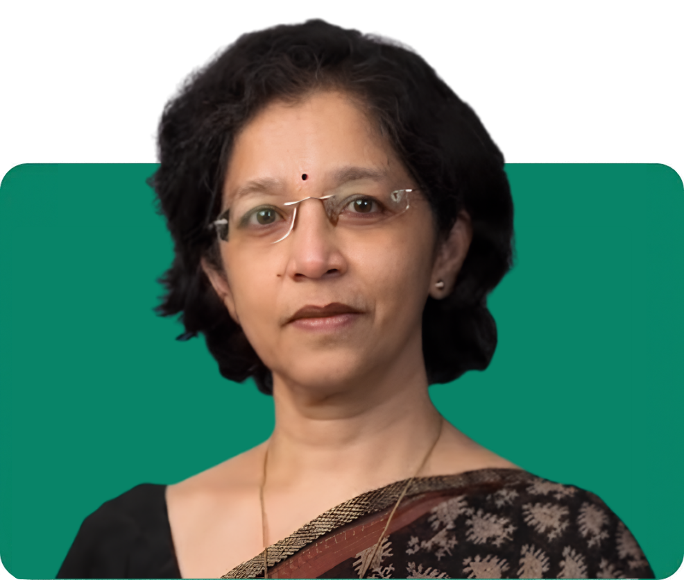 Professional woman in a saree, presenting a confident expression against a green background, featured on the About Us page.