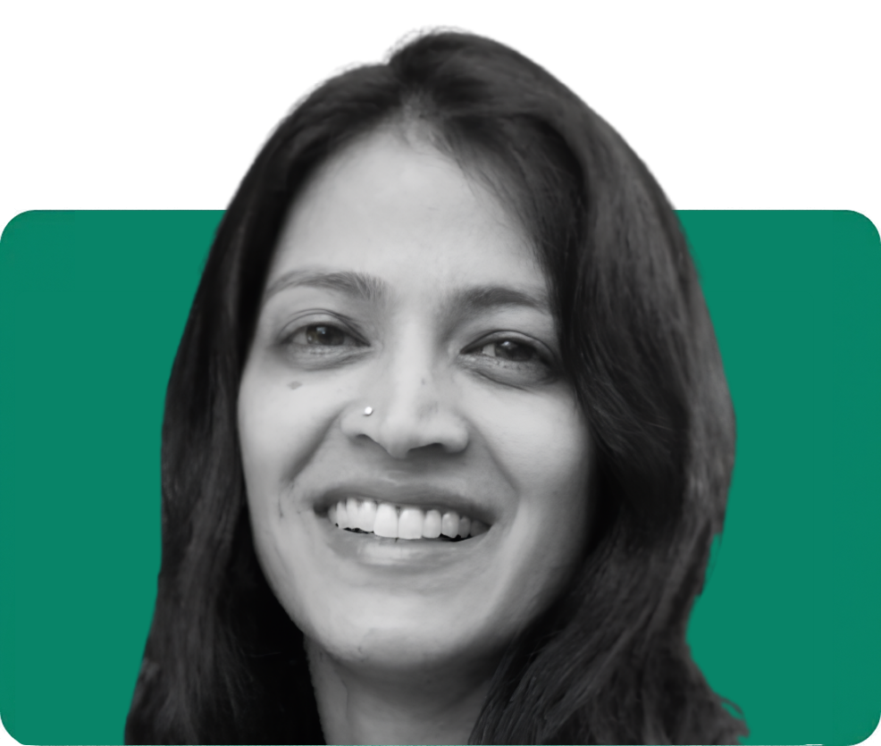 Smiling woman with long dark hair against a teal background, representing the team on the About Us page.