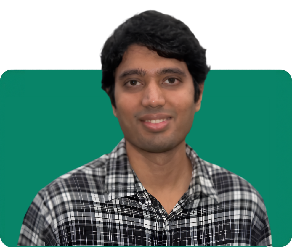 Team member with dark hair and a plaid shirt, smiling against a green background on the About Us page.