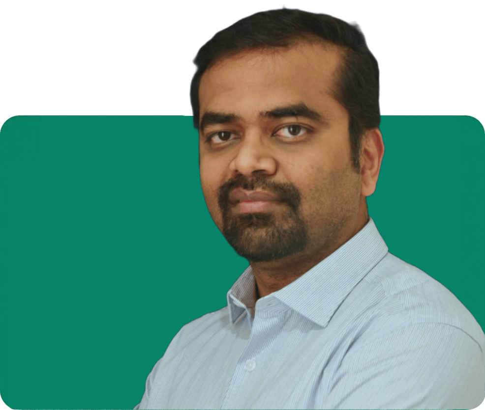 Portrait of a bearded man in a light blue collared shirt, looking calmly at the camera against a solid teal-green rounded backdrop.